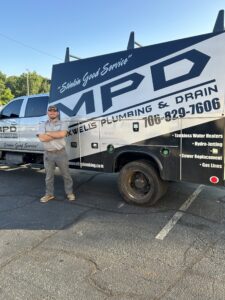Hunter Boose standing in front of MPD Work Truck