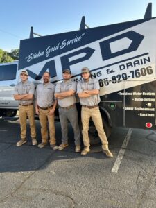 Christian, Charles, Hunter, and Charley standing in front of MPD Work Truck